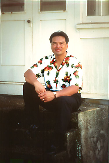 Larry in front of his family home.